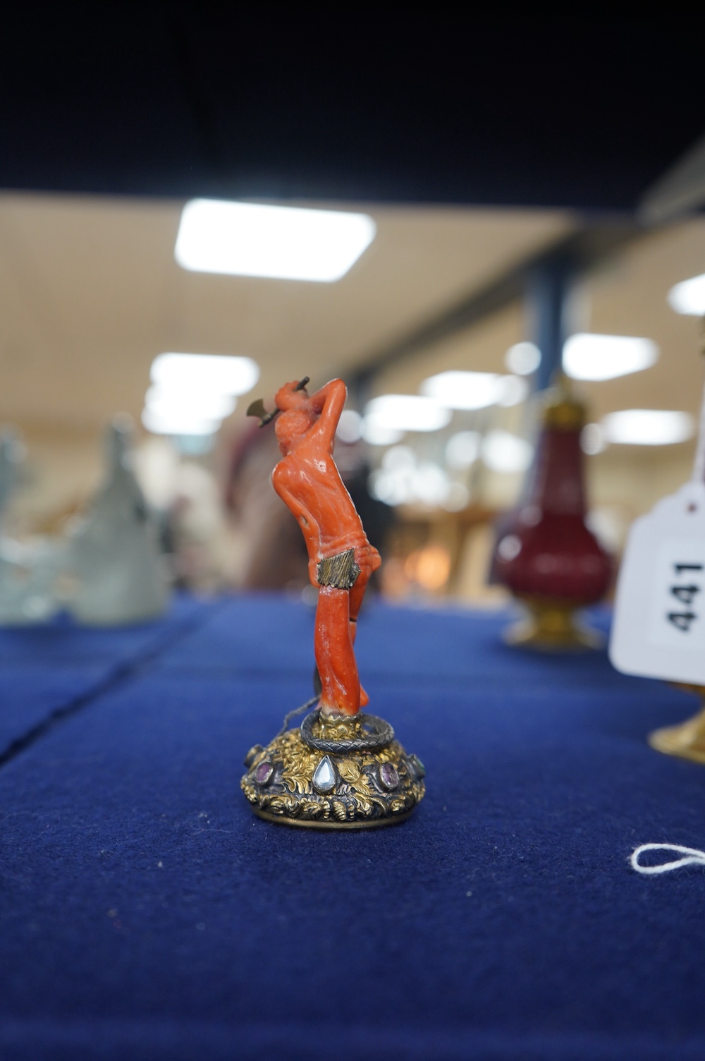 A 19th century French? gilt white metal, coral and multi gem-set table seal, modelled as a gentleman attacking a serpent with an axe, on a rustic gem set oval base, inset with carnelian, 93mm. Condition - poor